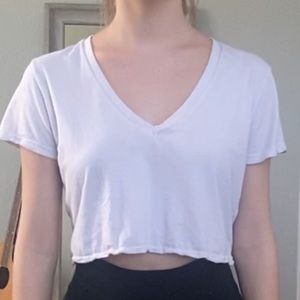 Very light pink cropped V-neck tee